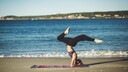 Frau macht Yoga am Strand.